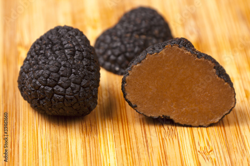 Black truffles on wooden background © Tomislav