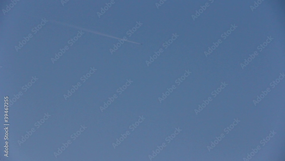vapor trail from an airplane on blue sky.
