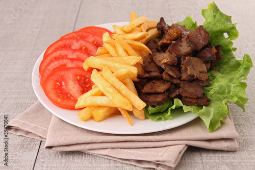 plate of meat, french fries and vegetables