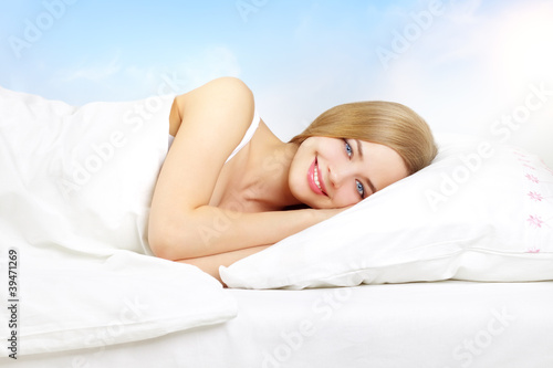Beautiful girl lying on a bed