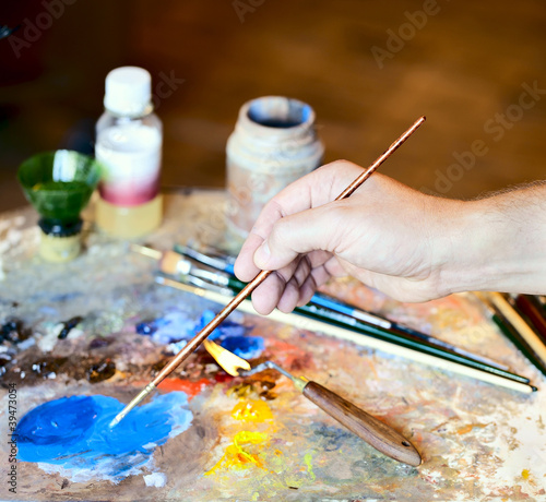 Hand of the artist with a paintbrush