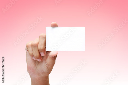 hand holding business card in red background.