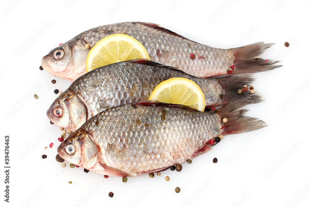 Fresh fishes with lemon and spice isolated on white Fresh fishes with lemon and spice isolated on white