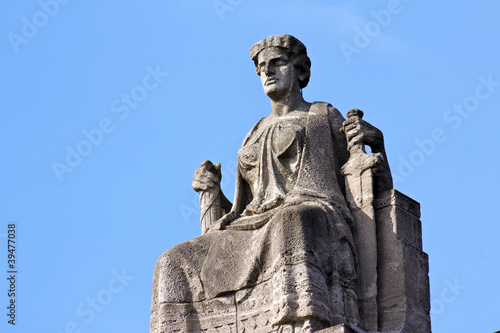 Justitia on Her Throne before a Clear Blue Sky