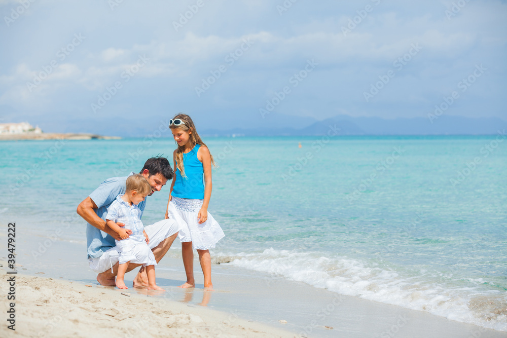 Father with her two kids on beach vacation Father with her two kids on beach vacation