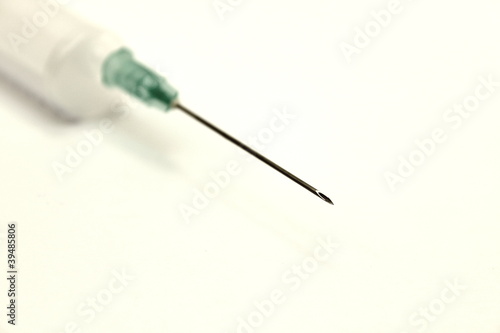 Medical needle with a syringe on a white background