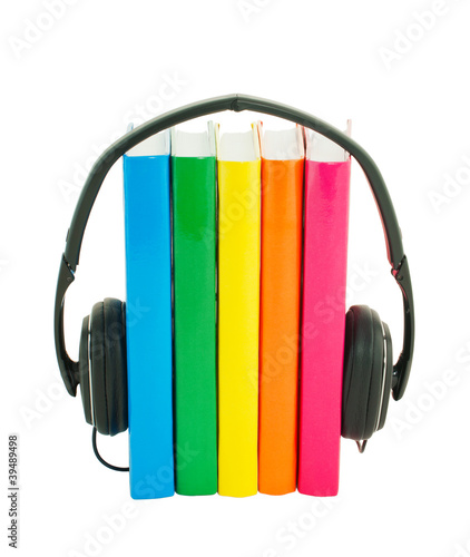 Row of books and headphones - Audiobooks concept