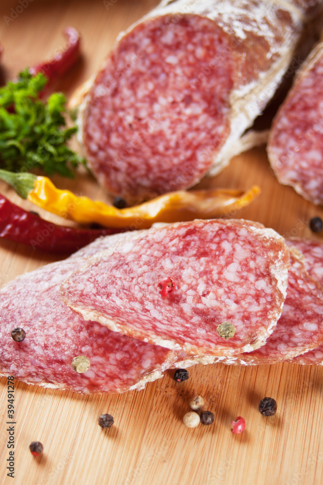 Sliced salami with chili peppers and herbs Sliced salami with chili peppers and herbs