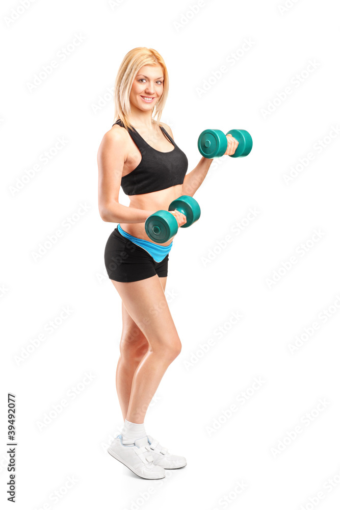 Full length portrait of an attractive woman lifting up weights Full length portrait of an attractive woman lifting up weights