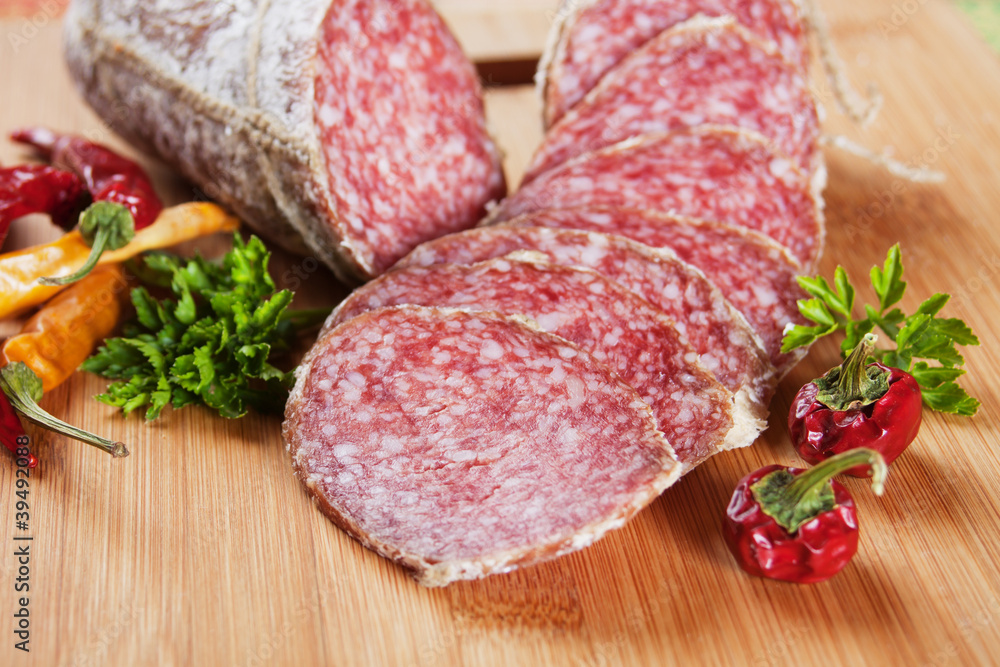 Sliced salami with chili peppers and herbs Sliced salami with chili peppers and herbs