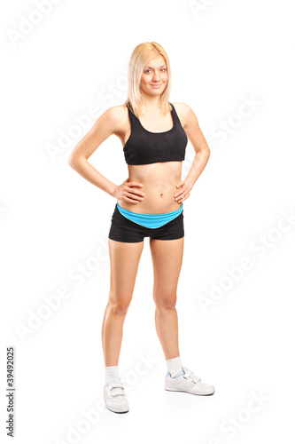 Full length portrait of an attractive female athlete posing