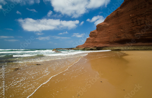 huge red cliffs on the beach Legzira. Morocco © jahmaica