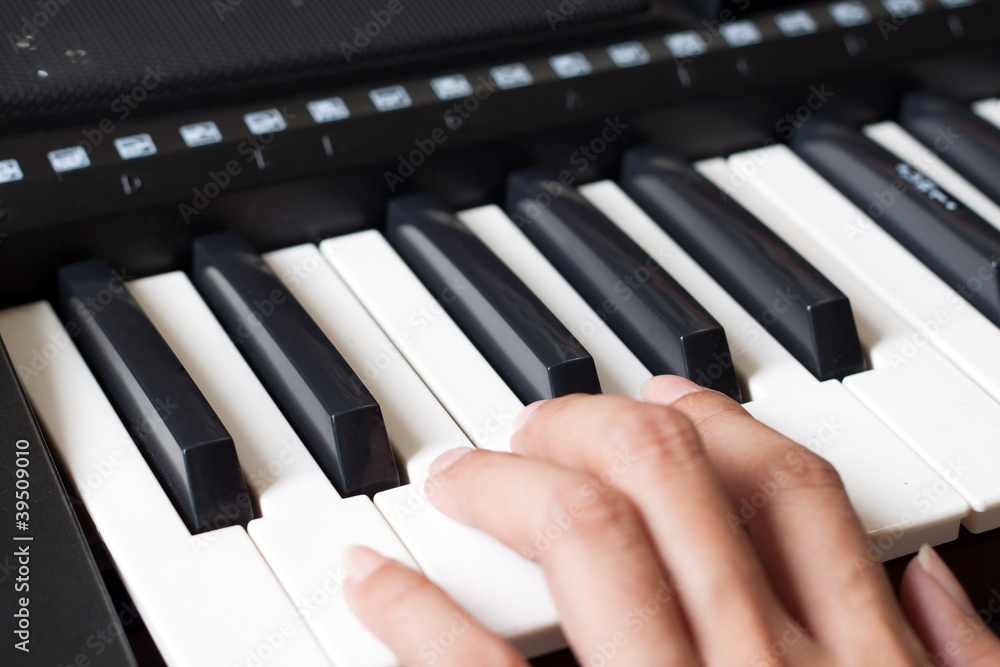 Fototapeta premium Piano keyboard with hand