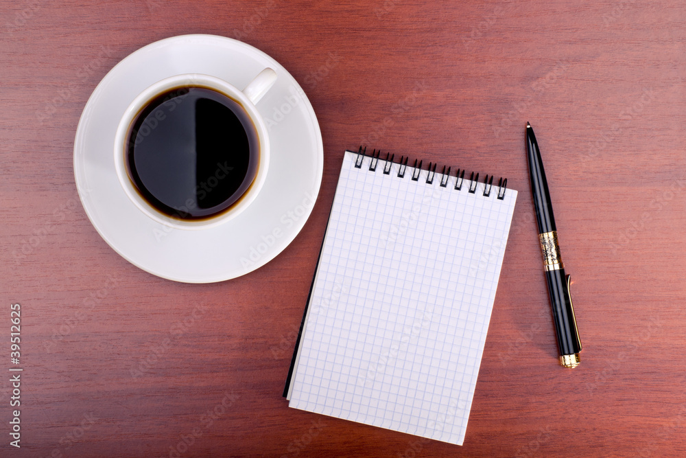 Cup of coffee, notebook and pen Cup of coffee, notebook and pen