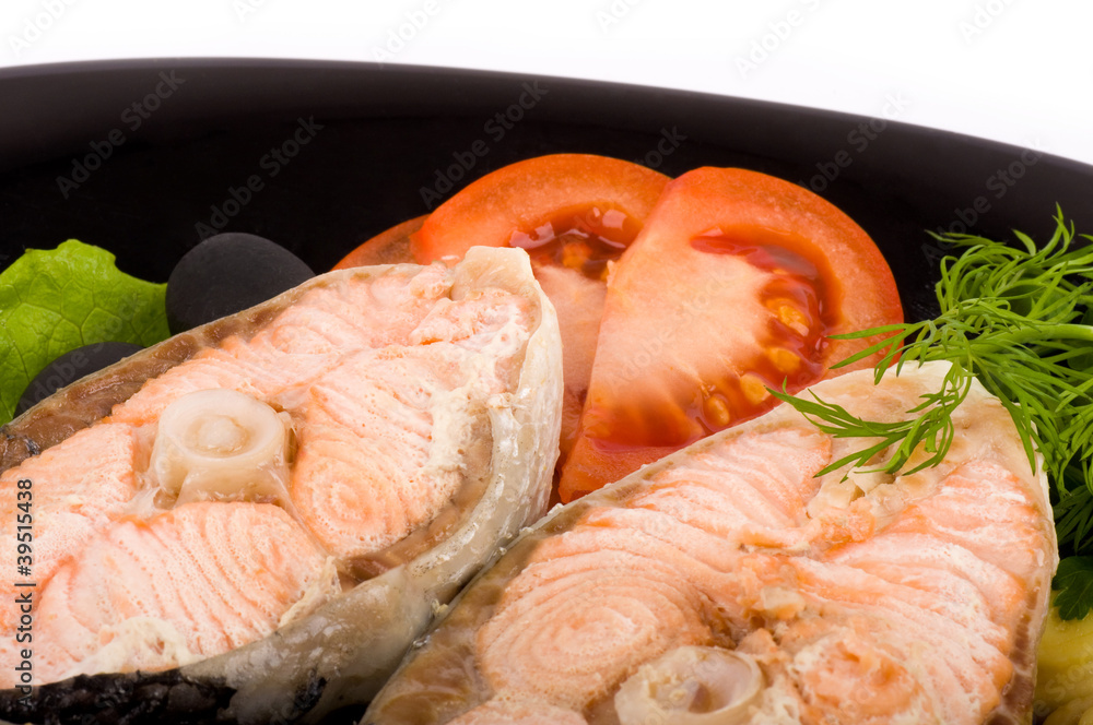 Boiled tasty salmon with vegetable on a white background Boiled tasty salmon with vegetable on a white background