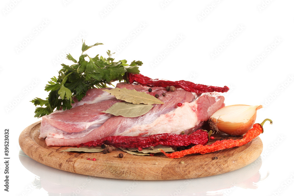 Raw meat and vegetables on a wooden board isolated on whitе
