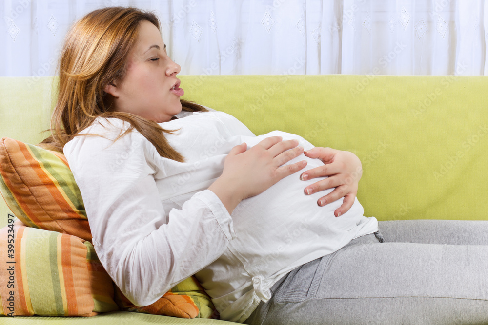 Pregnant woman doing breathing exercises Pregnant woman doing breathing exercises