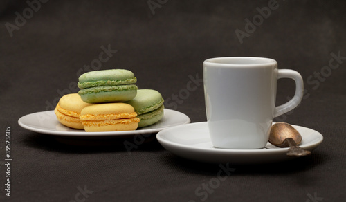 Cup coffee espresso and macaroon closeup on black