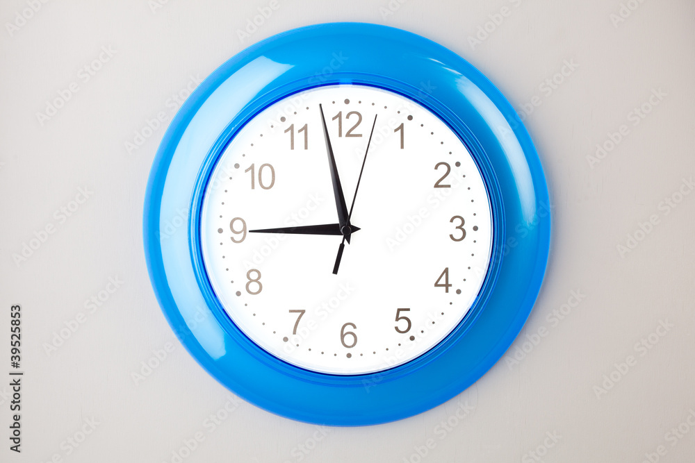 blue office clock on grey wall blue office clock on grey wall