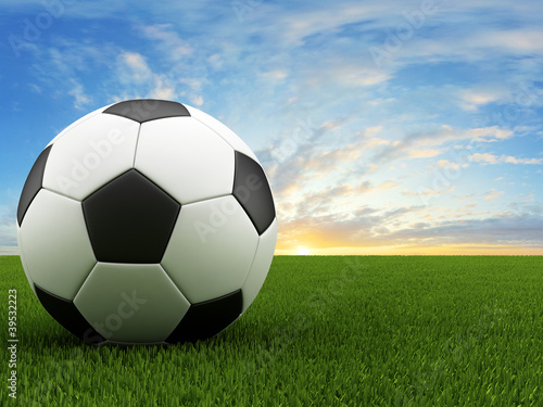 Soccer ball on green grass © yezep