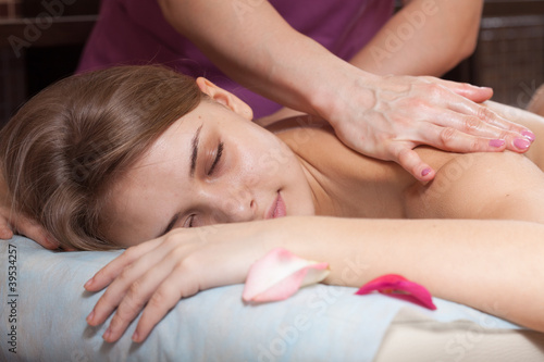 .Woman enjoying a massage in a spa setting