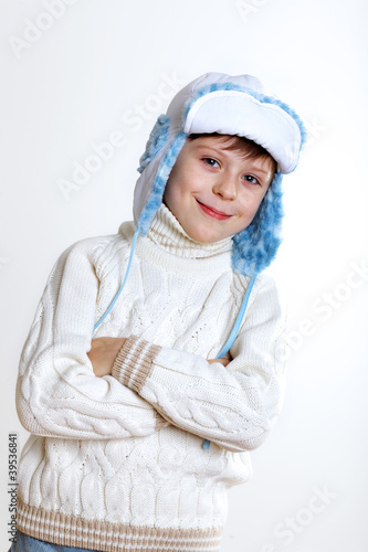 Kid in winter wear against white background