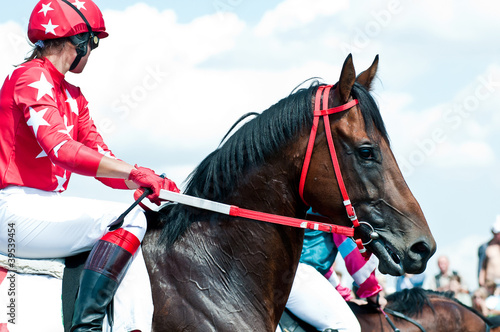 jockey on racing horse before the start