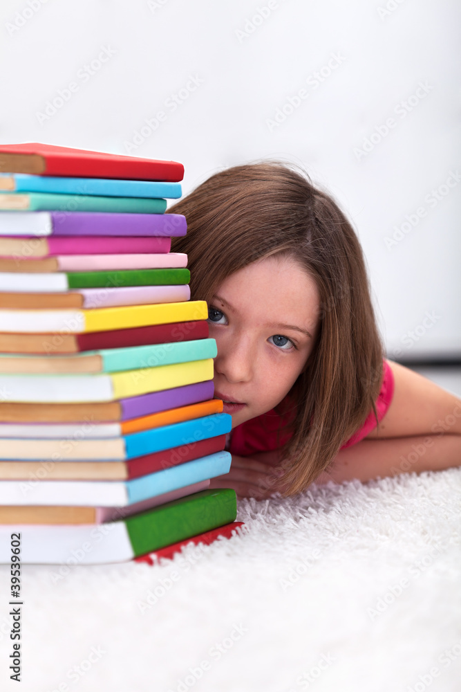Young girl hiding behind books Young girl hiding behind books