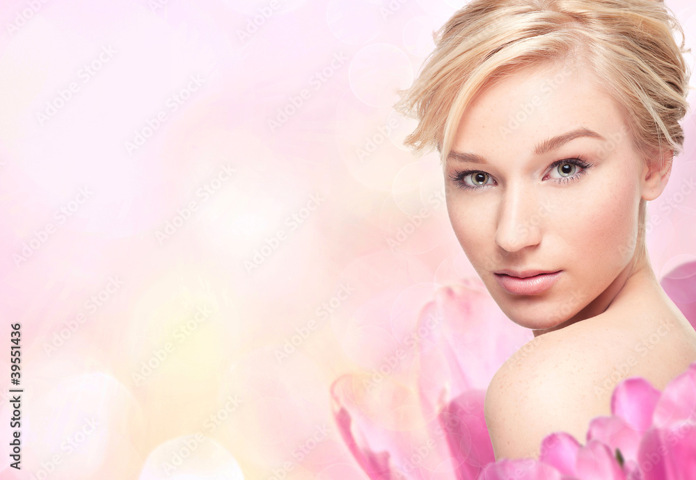 Young blond woman in flower petals Young blond woman in flower petals