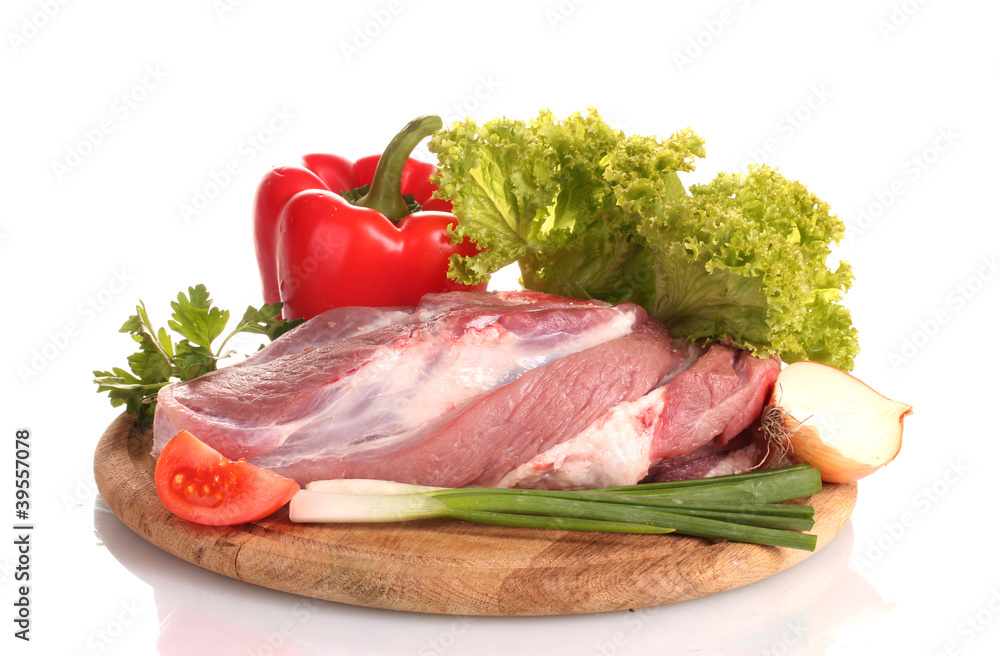 Raw meat and vegetables on a wooden board isolated on whitе Raw meat and vegetables on a wooden board isolated on whitе