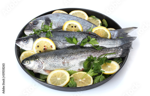 Fresh fishes with lemon, parsley and pepper