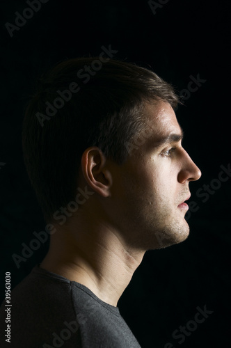 profile of young man on black