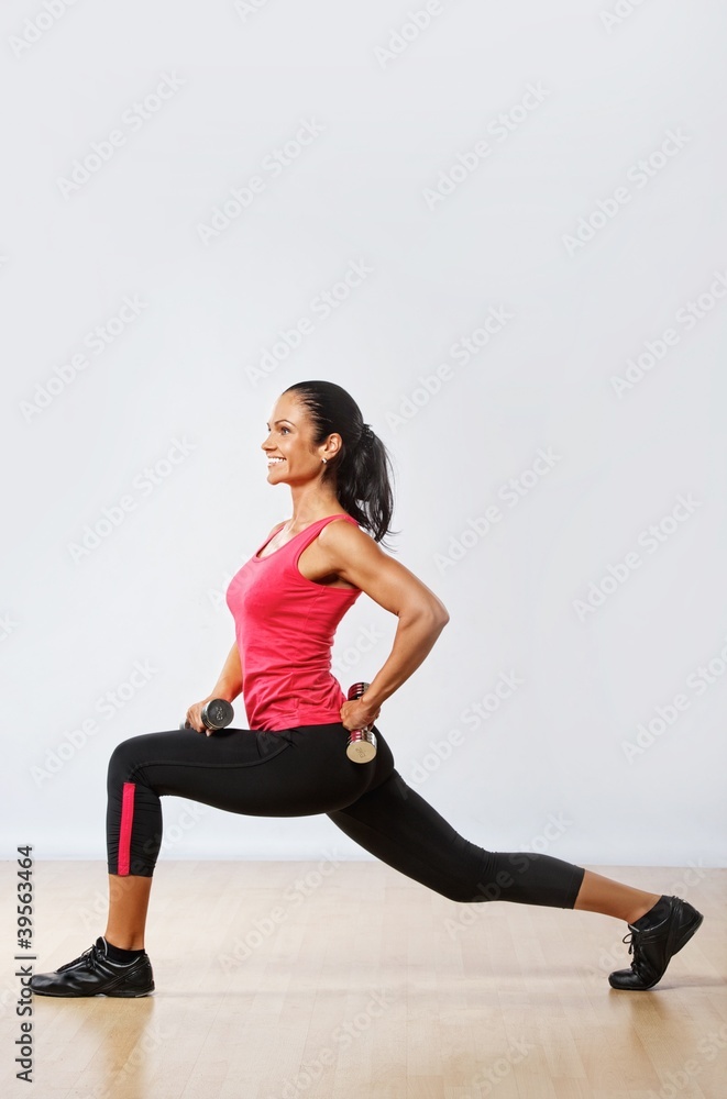 Beautiful woman exercising in fitness club.
