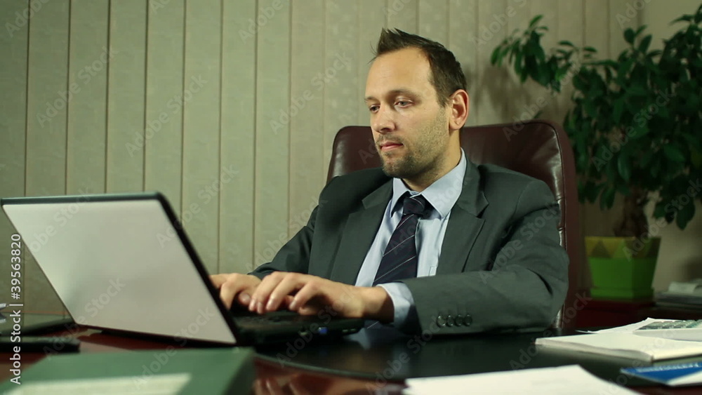 Businessman with laptop in office, steadicam shot Businessman with laptop in office, steadicam shot