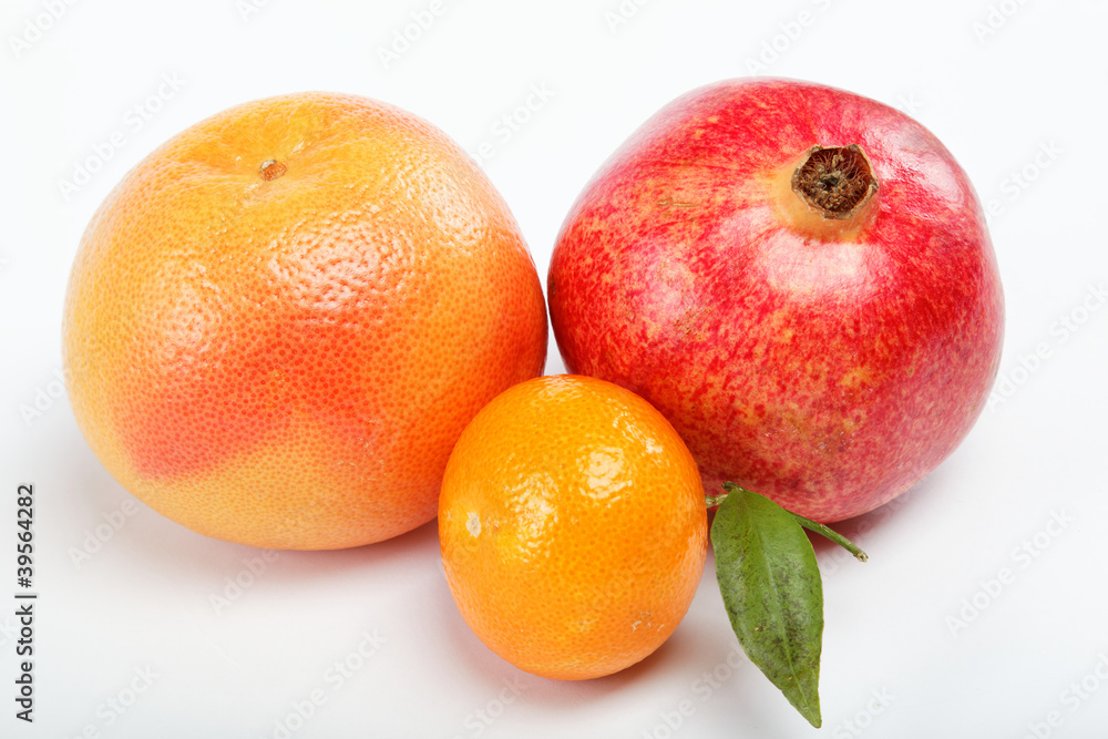 pomegranates and citrus fruits isolated on a white background. pomegranates and citrus fruits isolated on a white background.