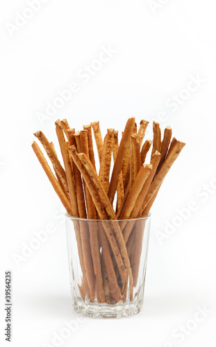 crispy bread straw in a glass on a white background.