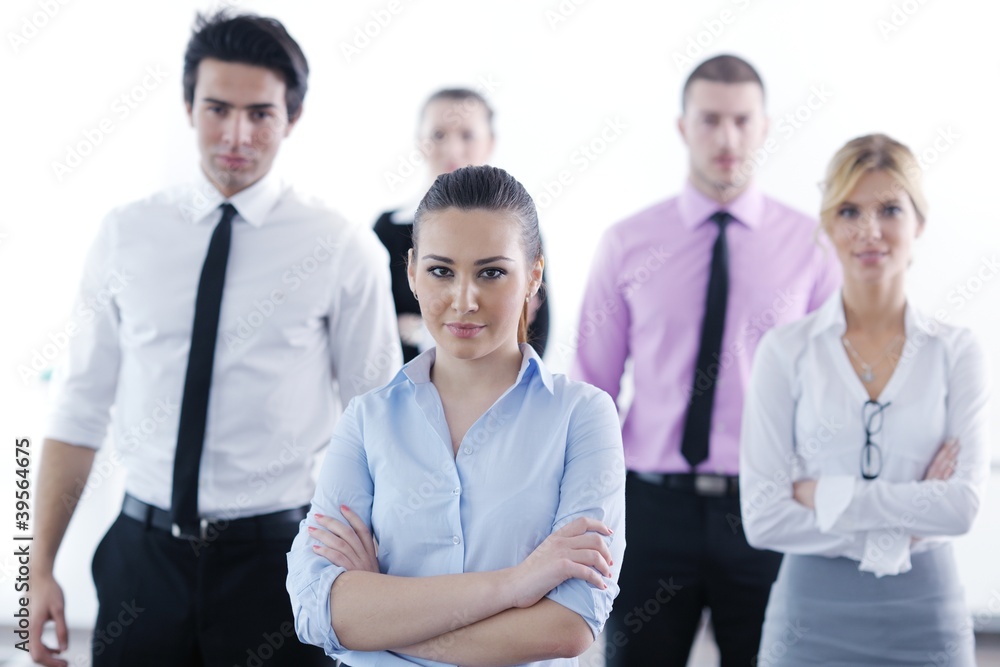 business woman standing with her staff in background business woman standing with her staff in background