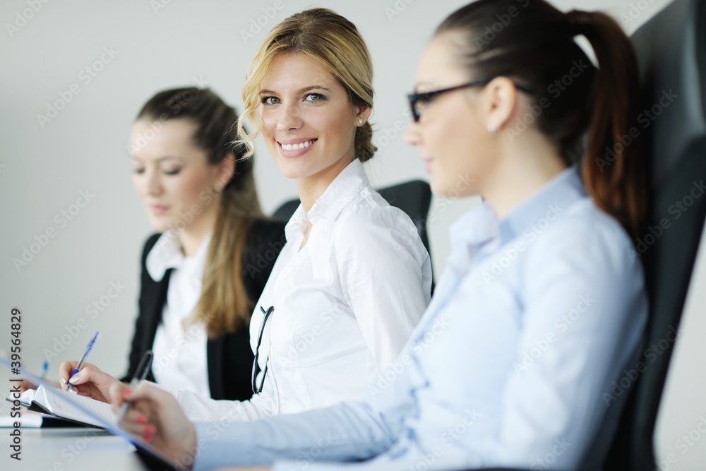 business woman standing with her staff in background business woman standing with her staff in background