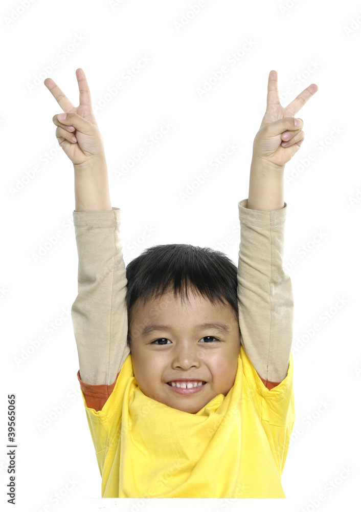 smiling young little boy gives a Victory Sign smiling young little boy gives a Victory Sign