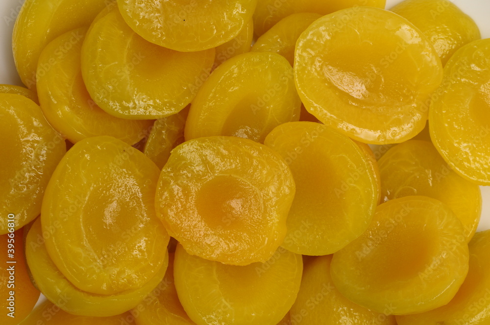 Orange Mumps apricots in syrup for background Orange Mumps apricots in syrup for background