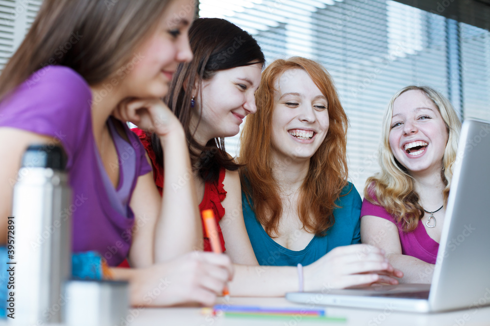 Four female college students working on their homework Four female college students working on their homework