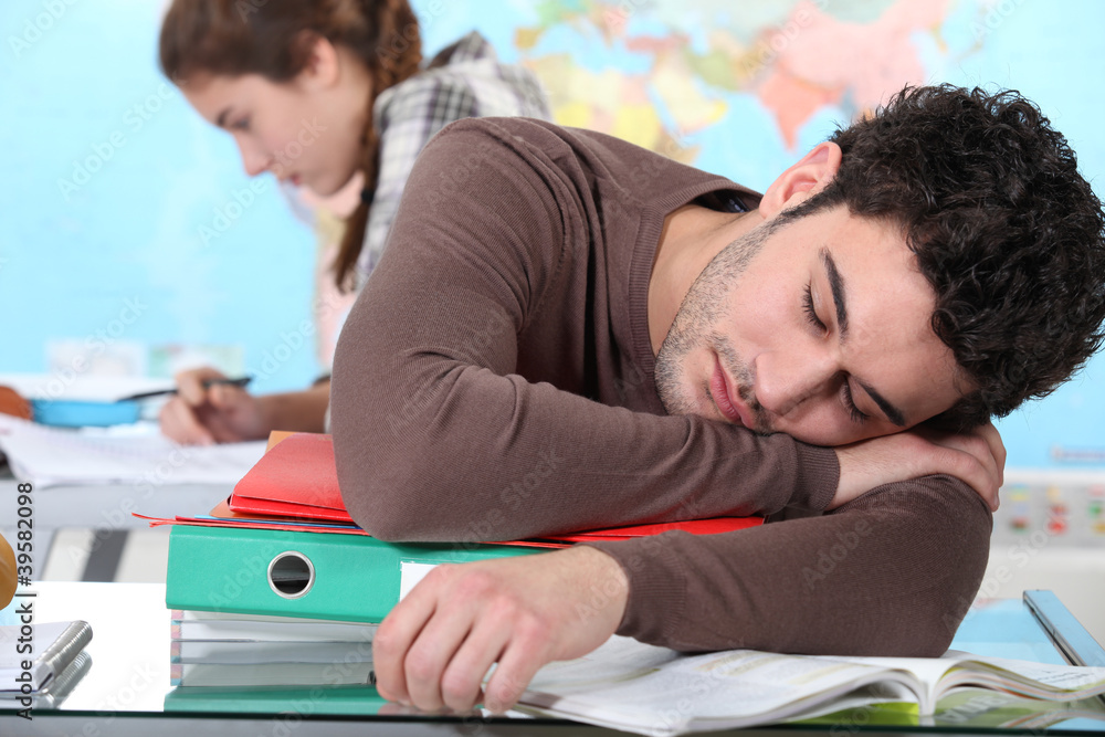 Young man sleeping during a university lecture Young man sleeping during a university lecture