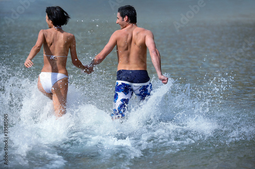 couple running in the sea
