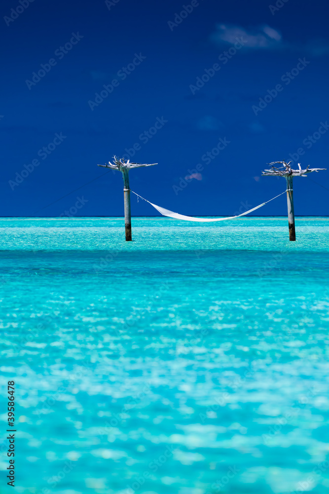 Empty over-water hammock in the middle of lagoon