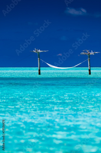 Empty over-water hammock in the middle of lagoon © Martin Valigursky
