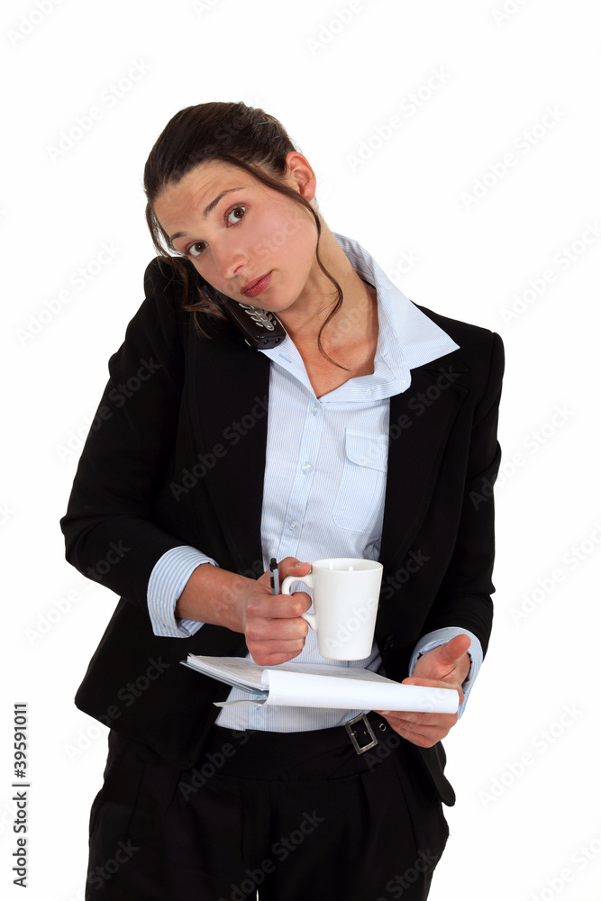 Woman on the phone with notebook and coffee in hand Woman on the phone with notebook and coffee in hand