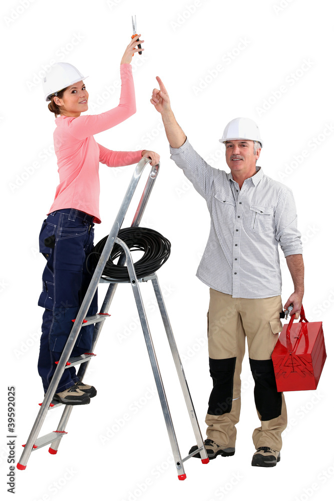 Experienced tradesman pointing to his assistant Experienced tradesman pointing to his assistant