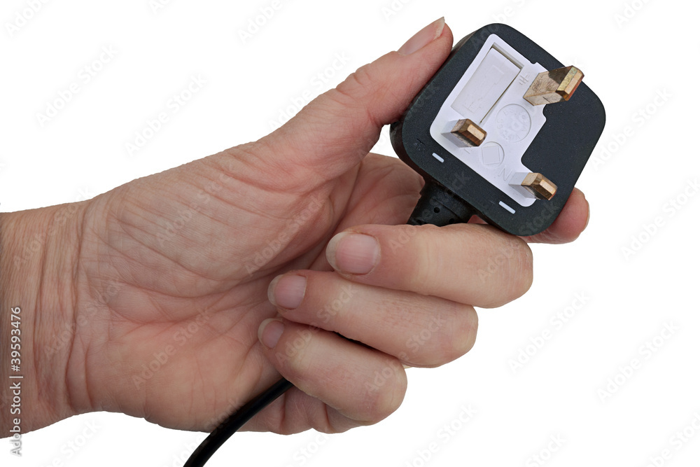 British standard 3 pin plug in hand, isolated over white British standard 3 pin plug in hand, isolated over white