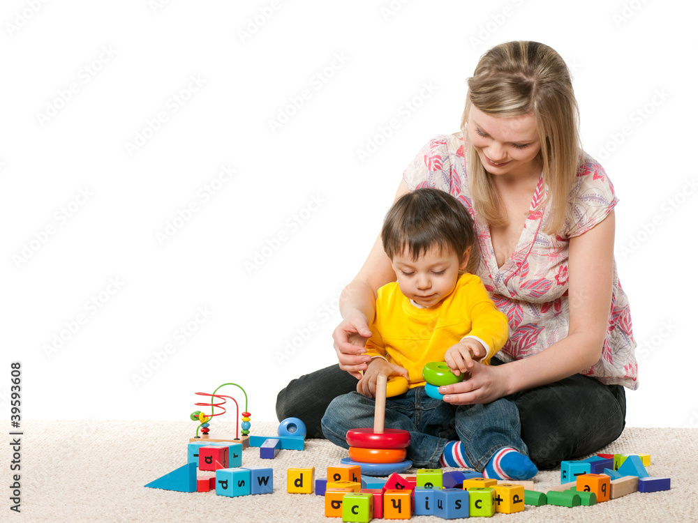 Mother and son on the carpet with toys Mother and son on the carpet with toys