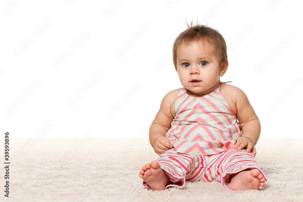 Baby girl is sitting on the carpet Baby girl is sitting on the carpet